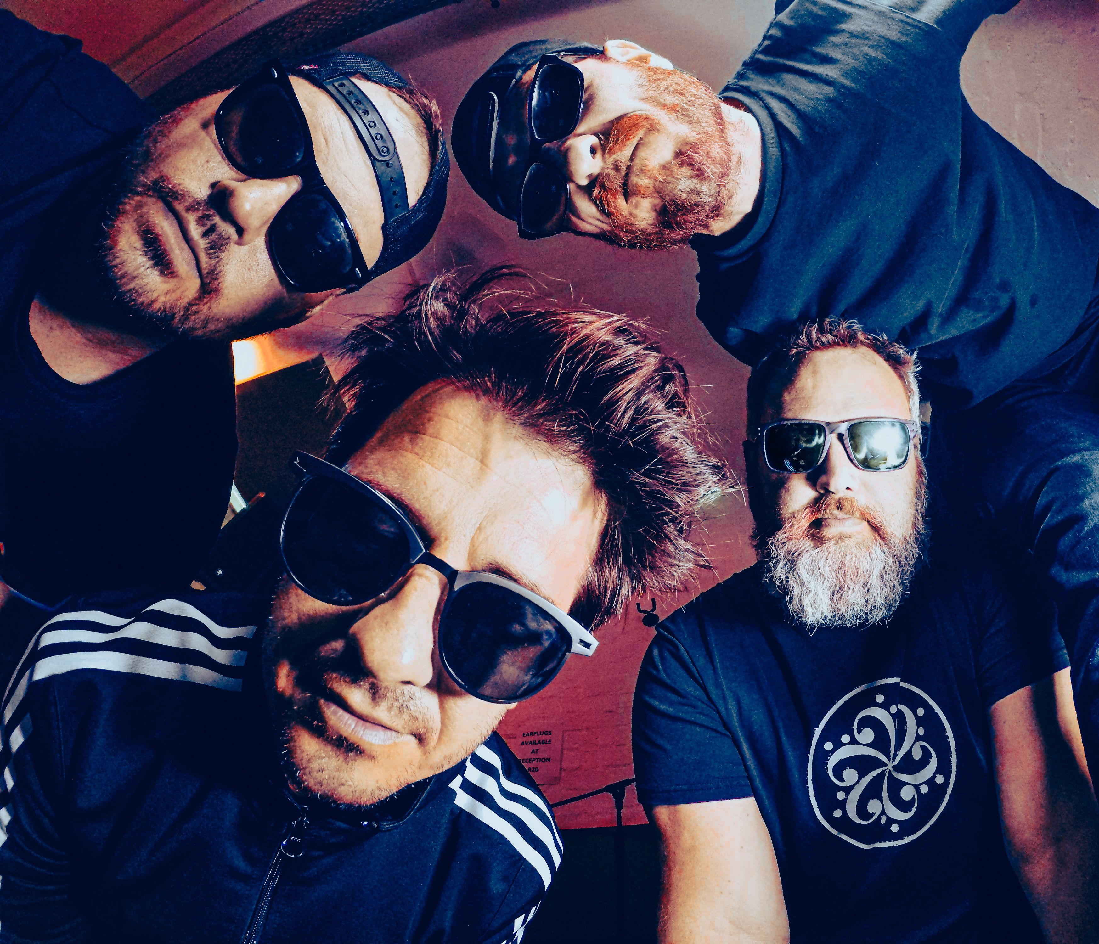 The four current members of Ill System photographed together in their rehearsal room